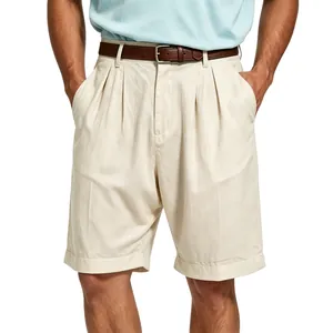 High quality close-up of pleated men's beige linen shorts with a brown leather belt