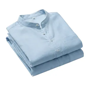 Macro view of light blue linen Henley shirt featuring wooden buttons and chest pocket