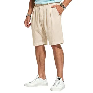 Detailed view of men's pleated beige linen shorts for a sophisticated summer look.