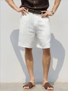 Stylish men's white breathable linen shorts styled with a brown belt and casual shirt