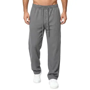 Full front view of men's grey waffle-knit casual pants with adjustable drawstring waist