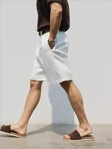 Detailed side view of premium white linen shorts for men in a summer vacation style
