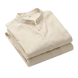 Folded beige linen Henley shirts featuring a classic chest pocket and natural fabric texture