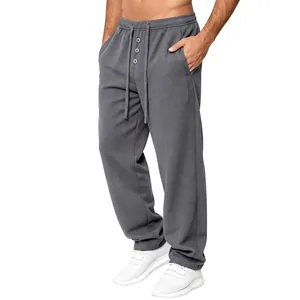 Detailed view of men's waffle knit lounge pants with drawstring waist in charcoal gray.