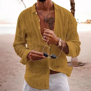 Close-up of a men's ochre yellow long-sleeved linen beach shirt featuring button-down style