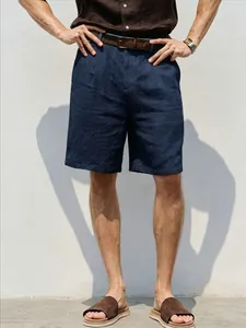 Detailed view of men's navy blue breathable linen shorts styled for a summer vacation