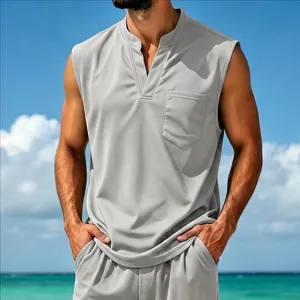 Mid-shot of grey sleeveless vest showing the fit and texture in a sunny beach setting