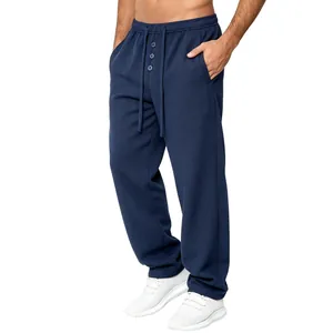 Close-up of men's waffle-knit casual trousers featuring drawstring waist and buttons.