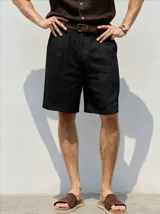 Detailed view of men's loose black linen shorts for a breathable summer casual look
