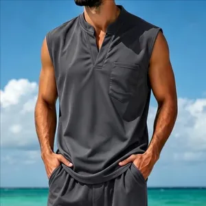 Close-up of men's quick-dry dark gray V-neck sleeveless top in a beach setting.