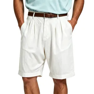 Detail showing the textured linen fabric and pleated waist of white men's shorts.