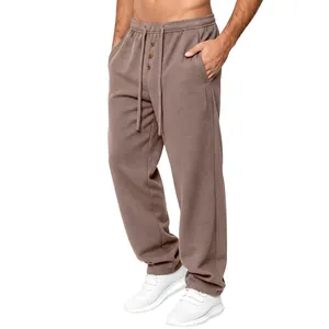 Detail view of men's waffle knit loose drawstring casual trousers in brown color
