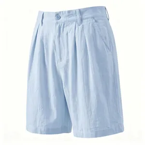 Close-up of light blue linen shorts showing breathable fabric and pleated front design