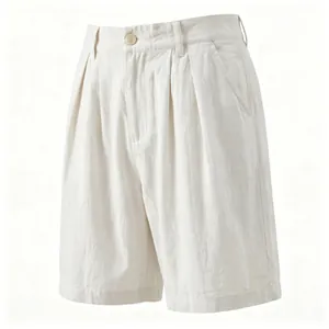 Detailed macro view of men's breathable white linen shorts featuring pleated front design