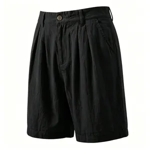 Detailed view of men's black pleated linen shorts featuring breathable fabric texture