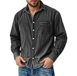 Detail shot of men's washed black denim shirt with chest pocket and white buttons.