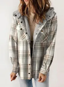 Macro view of women's hooded plaid jacket with warm grey fleece lining and button detail