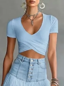 Close-up detail of a light blue V-neck short sleeve crop top with stylish crossover waist