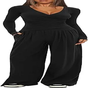 Detail view of black two-piece lounge set with V-neck long sleeve top and wide pants.