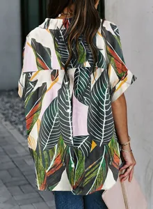 Detailed back view of a woman wearing a tropical leaf print shirt with a loose fit.
