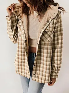 Detail of women's plaid hooded jacket featuring warm fleece lining and chest pockets