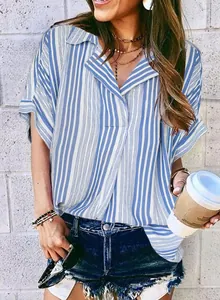 Stylish woman wearing a blue and white striped V-neck Polo shirt in a casual outdoor setting