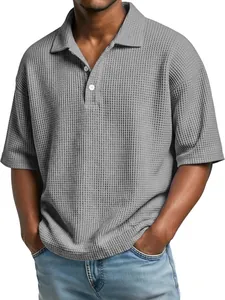 Detailed view of grey men's waffle knit Polo shirt with buttoned collar and short sleeves