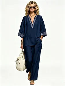 Full length view of a stylish navy bohemian linen V-neck top and wide-leg trousers