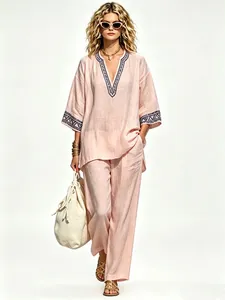 Full detail view of pink bohemian linen two-piece set featuring elegant V-neck embroidery