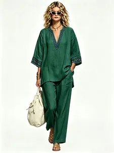 Bohemian green linen two-piece set with V-neck top and wide-leg pants on model