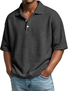 Detail of men's dark grey waffle knit polo shirt with classic lapel collar