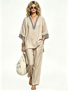 Elegant bohemian linen two-piece set featuring V-neck embroidered tunic and wide-leg trousers