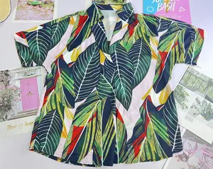 Macro detail view of vibrant tropical leaf print on V-neck Polo shirt with short sleeves