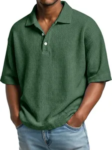 Close-up detail of waffle knit texture on a green men's polo shirt with white buttons