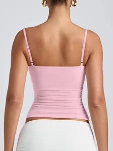 Detail view of pink camisole with adjustable straps and low back design for women.
