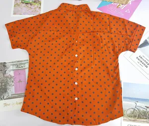 Detailed back view of orange polka dot short sleeve shirt with unique button-up design.
