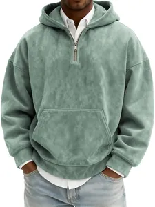 Macro detail of men's sage green suede half-zip hoodie featuring front kangaroo pocket