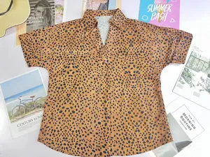 Detailed view of women's leopard print V-neck polo shirt in a summer lifestyle setting
