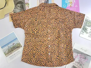 Detailed view of women's leopard print polo shirt with half sleeves and button back