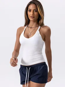 Model wearing a white V-neck ribbed halter sports tank top against a neutral background