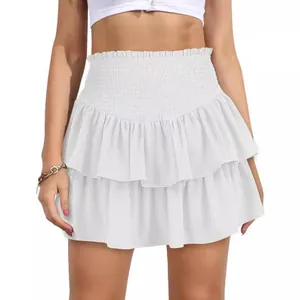 Front view detail of a white bohemian high-waisted tiered ruffle mini skirt worn by a model