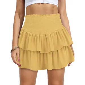 Detailed view of yellow smocked high waist ruffled mini skirt with tiered layers