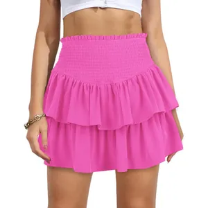 Detailed view of vibrant pink high-waisted smocked ruffled mini skirt for summer