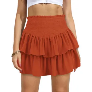 Close-up detail of a Bohemian style burnt orange smocked high waist ruffled mini skirt