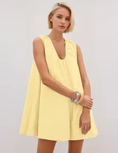 Elegant sleeveless light yellow mini dress featuring a pleated deep V-neck on a model