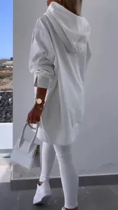 Detailed back view of women's white oversized hooded sweatshirt and tight leggings set.