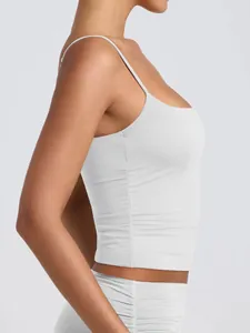 Side view detail of woman wearing light gray scoop neck camisole with adjustable straps