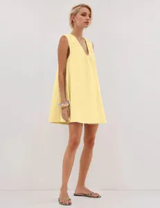 Detailed side view of a minimalist pale yellow V-neck sleeveless A-line dress for women