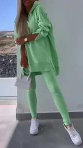 Full-length detail of a lime green oversized slit hoodie and matching ribbed leggings set