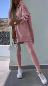 Detailed view of pink two-piece workout set with side-slit hoodie and leggings